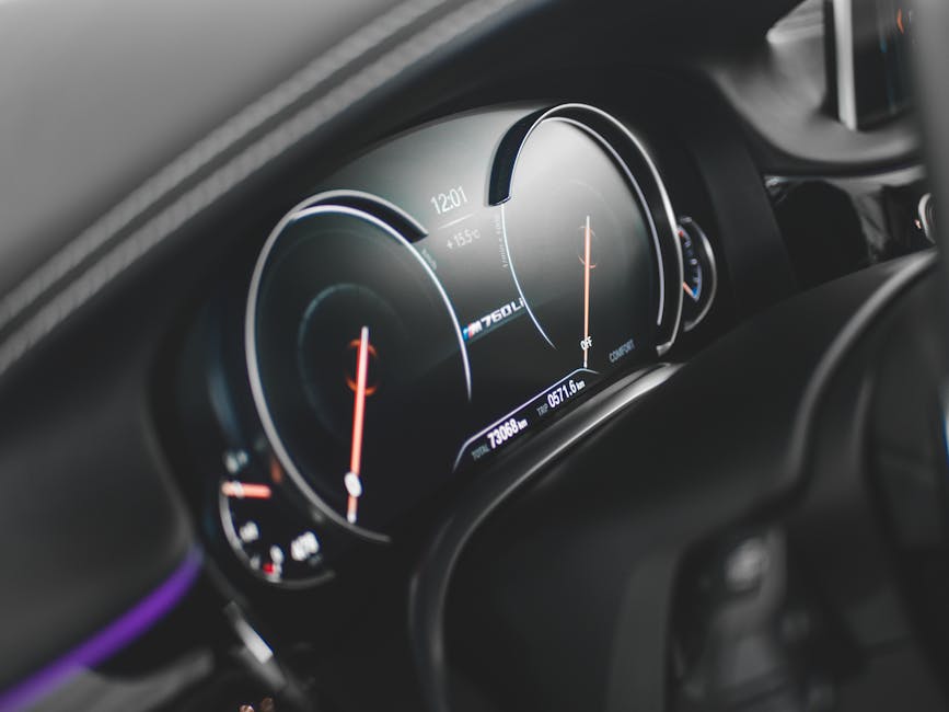 Close-up view of a sleek digital car dashboard featuring a modern speedometer and tachometer.